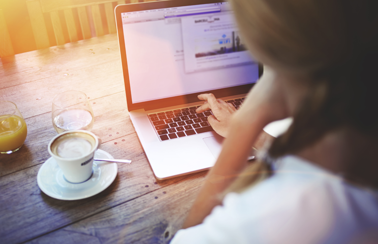 young female person studying online using a computer